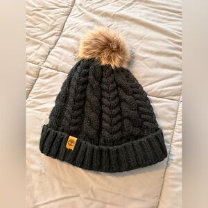 Women’s Timberland Black Cable Knit Beanie with Faux Fur Pom-Pom